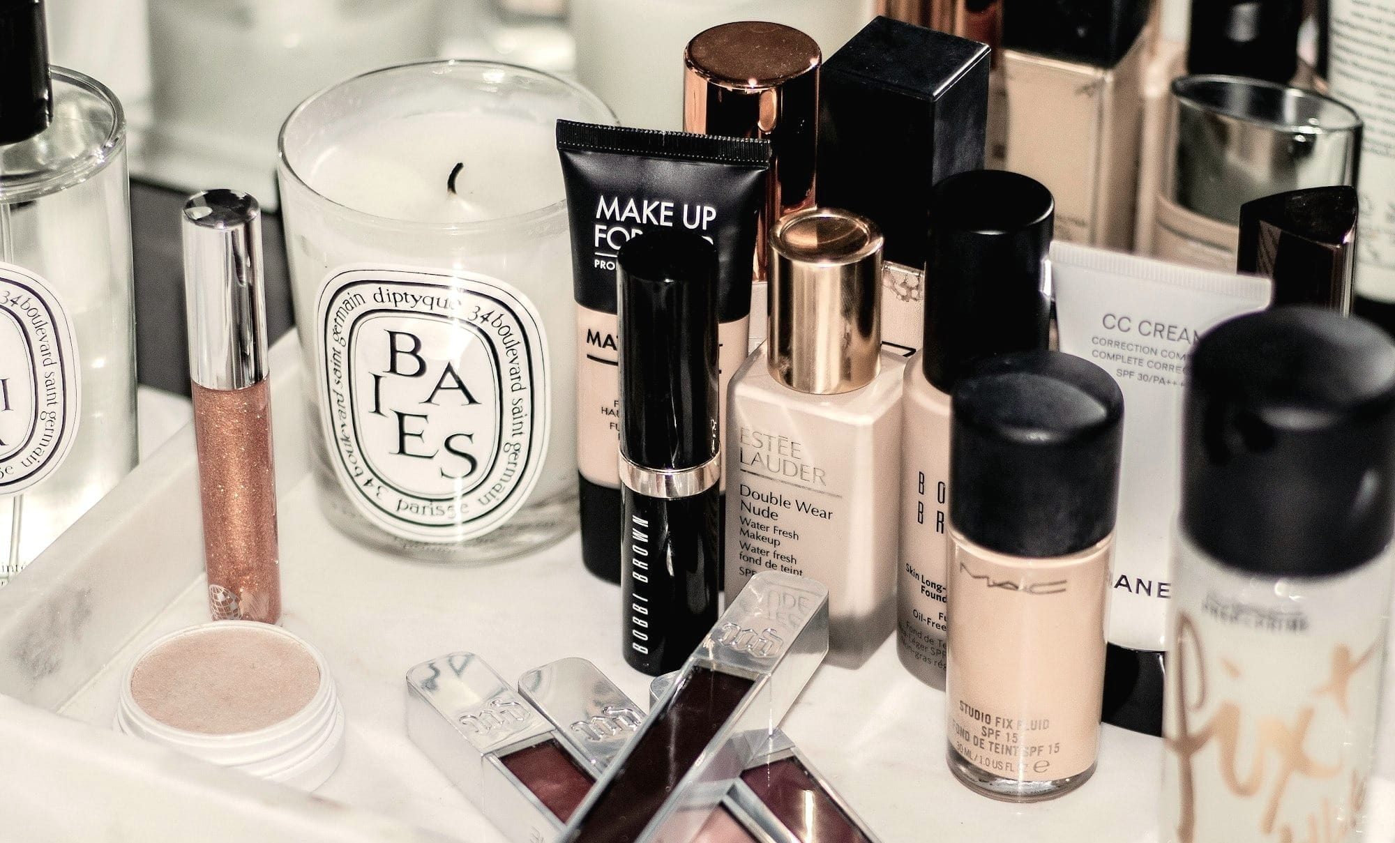 assorted make up brushes on white table